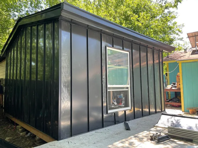 Black standing seam metal wall panels for Metal Roof Installation in Adel